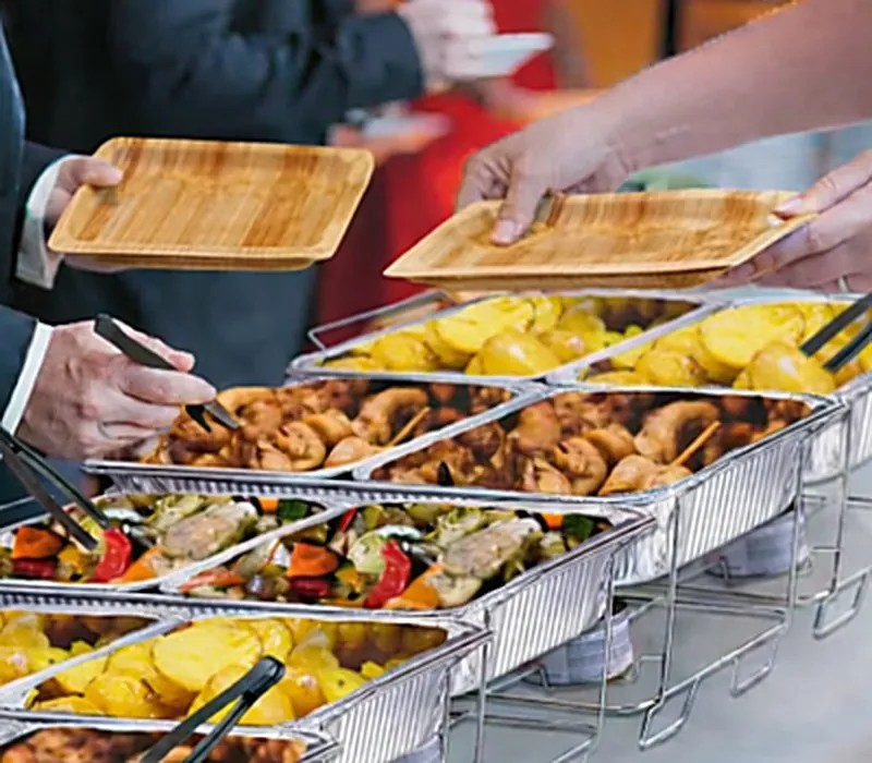 Dropoff catering buffet with chafing dishes and serving utensils set up for an Atlanta office meeting